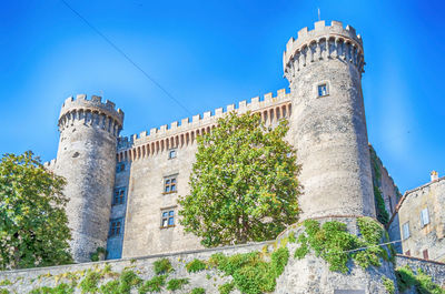 Low angle view of historical building against blue sky