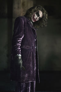 Portrait of man wearing joker costume during halloween