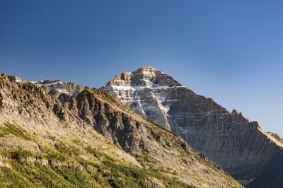 Scenic view of mountains against blue sky