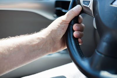 Close-up of man hand holding car