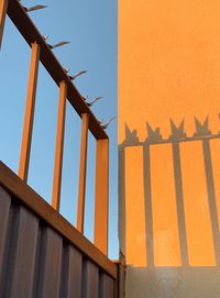 Low angle view of security gate and its shadow against sky in malaga, spain.