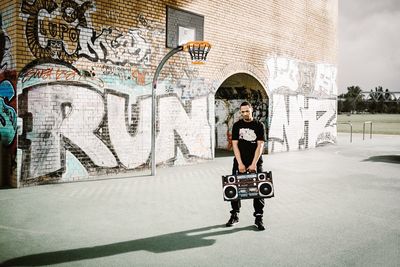 Full length of man with bicycle in city