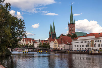 River amidst buildings against sky in city