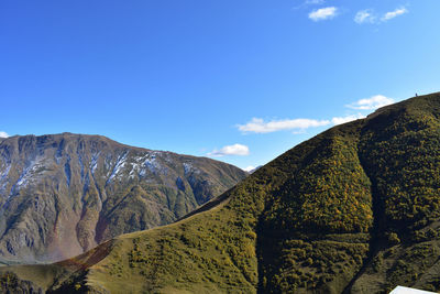 Scenic view of mountains against blue sky