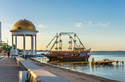 Commercial dock by sea against sky