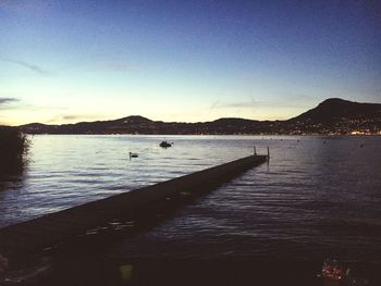 Scenic view of sea against clear sky during sunset