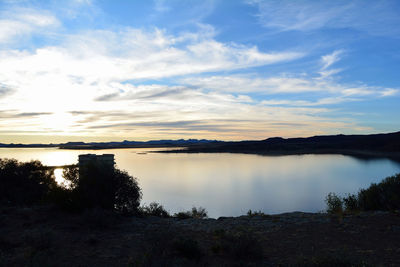 Scenic view of lake at sunset