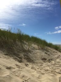 Scenic view of sandy beach against blue sky