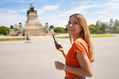 Portrait of a young brazilian girl happy with her smartphone. copy space.