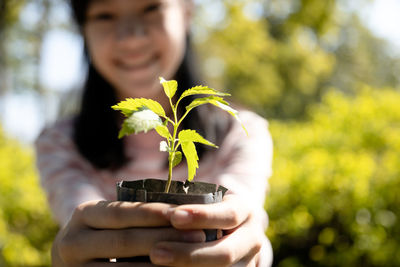Midsection of man holding plant