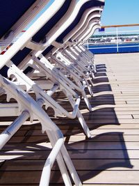 Close-up of wooden chairs at beach