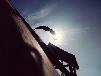 Low angle view of silhouette built structure against sky