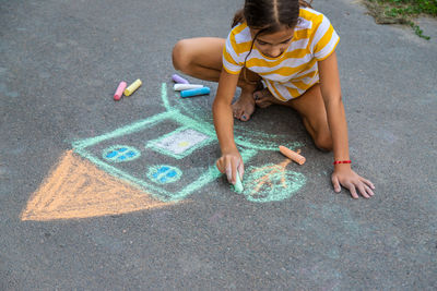 High angle view of boy playing on street