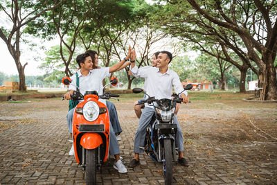 Side view of woman riding motorcycle on field