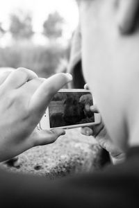 Close-up of man photographing