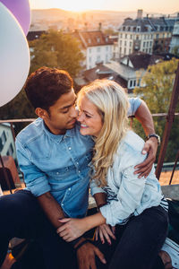 Young couple sitting outdoors