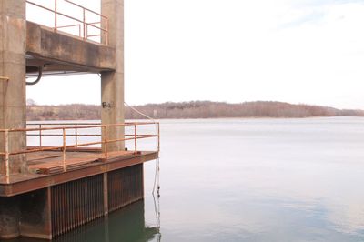 Abandoned industrial concrete structure overlooking a calm ozarks lake in rural america.