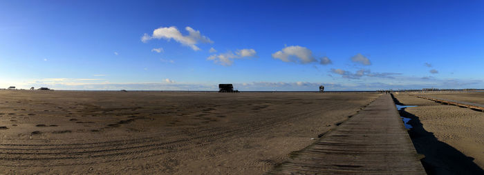 Scenic view of beach against blue sky