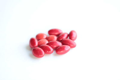 Close-up of tomatoes over white background