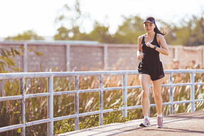 Full length of woman on railing against bridge