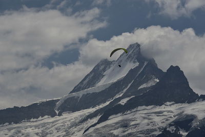 Low angle view of snowcapped mountain against sky