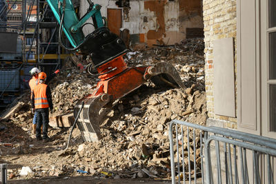 Ruined destroyed house. an excavator destroys a house with a bucket.