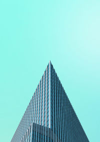 Low angle view of skyscraper against clear blue sky