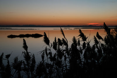 Scenic view of lake against romantic sky at sunset