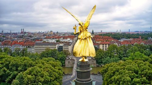 Low angle view of statue against buildings in city