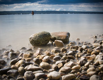 Rocks in sea against sky