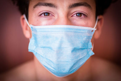 Close-up portrait of teenage boy wearing mask