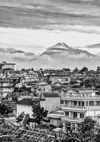 High angle view of city against cloudy sky