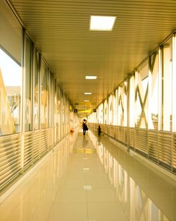 Man walking in illuminated corridor