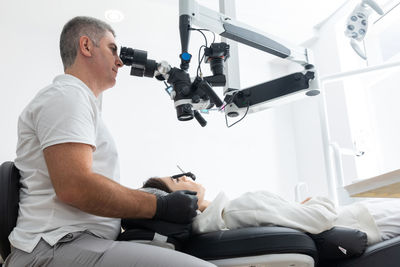 Side view of man exercising in clinic