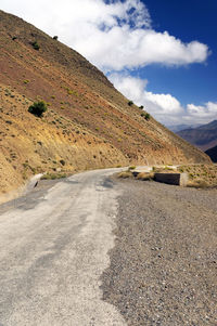 Road by mountain against sky