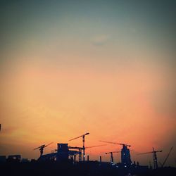 Low angle view of silhouette built structure against sky at sunset