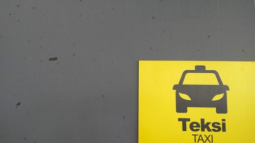 Close-up of yellow text on wall