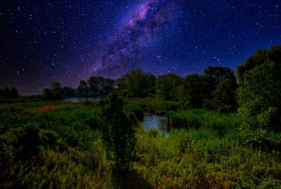 Scenic view of lake against sky at night