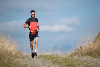 Full length of man running on road