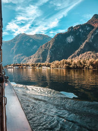 Scenic view of lake by mountains against sky