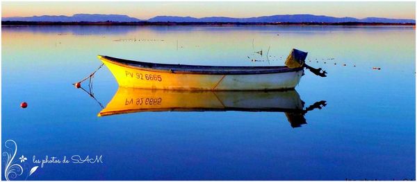 Close-up of boat in lake against sky