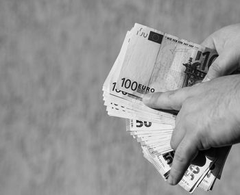 Cropped hand holding paper currency