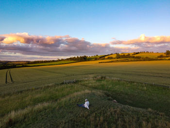 Scenic view of field against sky during sunset