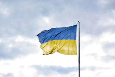 Low angle view of flag against sky