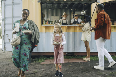 Multiracial customers buying food at truck