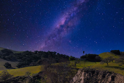 Scenic view of landscape against sky at night