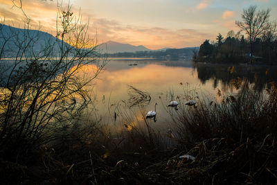 Scenic view of lake against sky at sunset