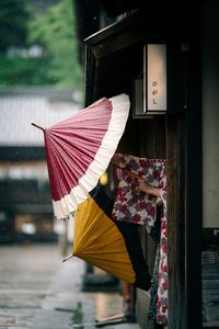 Umbrella on wet glass window in city