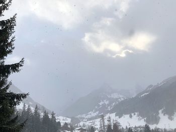 Low angle view of mountains against sky during winter