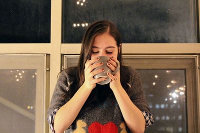 Portrait of beautiful woman drinking glass